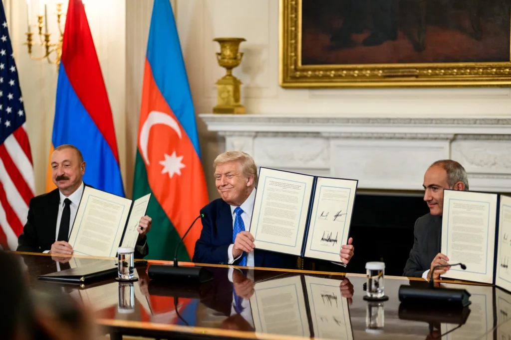 President Donald Trump, Azerbaijani President Ilham Aliyev, and Armenian Prime Minister Nikol Pashinyan hold signed peace agreements at the White House in Washington, D.C., August 8, 2025.